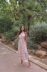 a lady in a pink floral printed dress